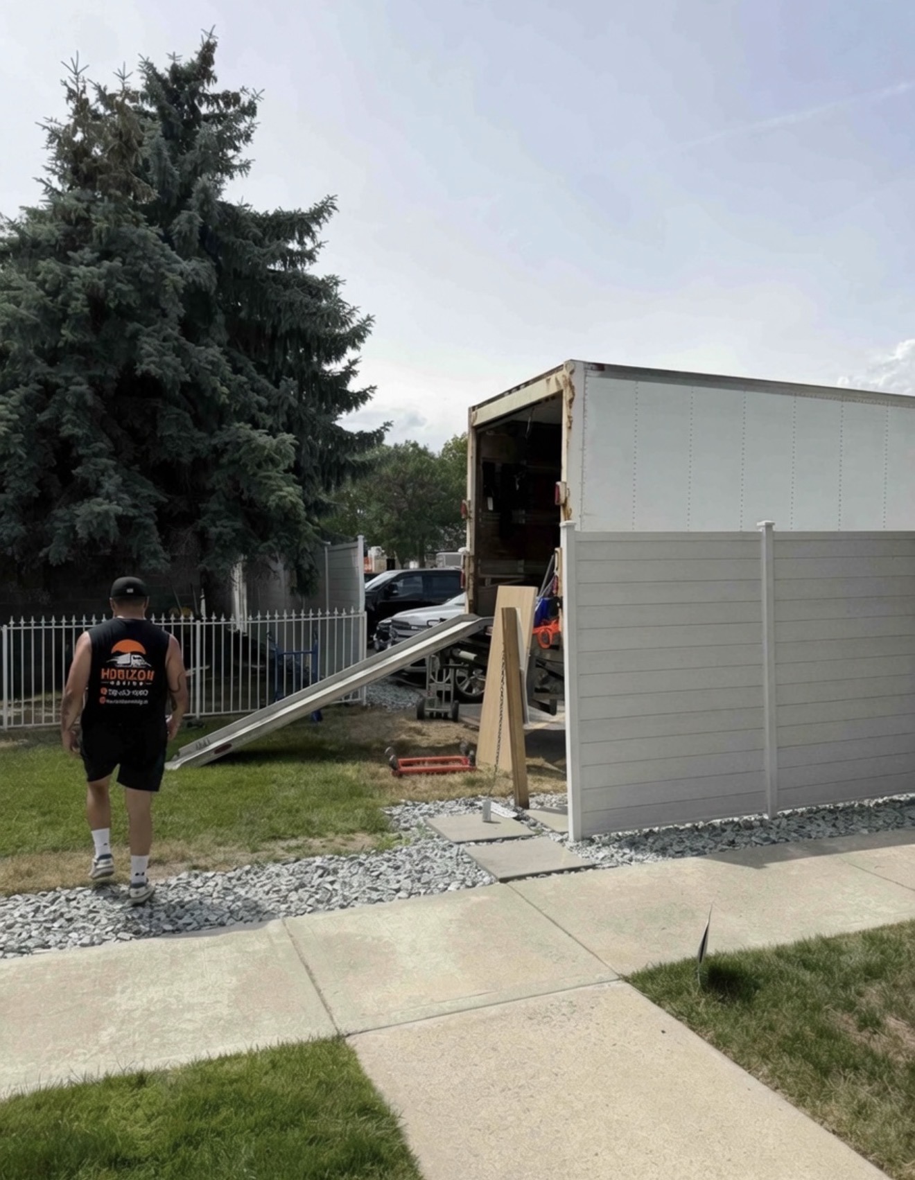 Professional mover walking to a loaded moving truck at a Kelowna home
